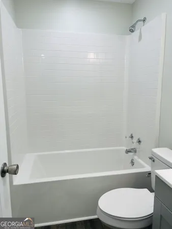 a bathroom with a toilet and a bathtub