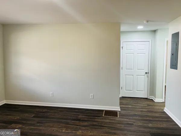 a view of an empty room with wooden floor