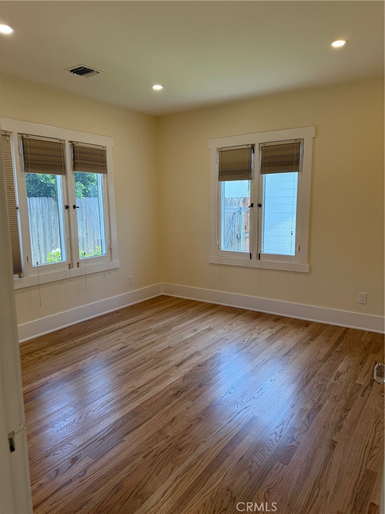 297 Garfield Avenue Pasadena, CA 91101 - Photo 14 of 28 an empty room with wooden floor and windows