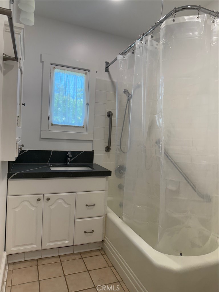 297 Garfield Avenue Pasadena, CA 91101 - Photo 19 of 28 a bathroom with a sink a bathtub and a shower