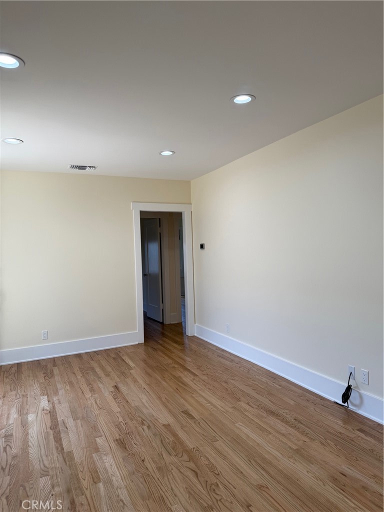 297 Garfield Avenue Pasadena, CA 91101 - Photo 7 of 28 an empty room with wooden floor and natural light