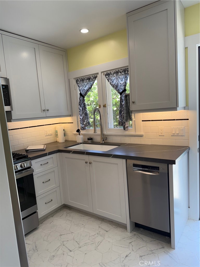 297 Garfield Avenue Pasadena, CA 91101 - Photo 9 of 28 a kitchen with granite countertop a sink and cabinets