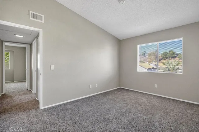 an empty room with windows and closet