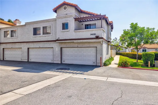 a view of a house with a yard and garage