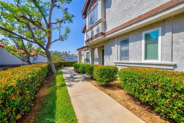 a view of brick house with a yard