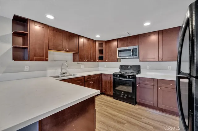 a kitchen with stainless steel appliances granite countertop a sink stove microwave and cabinets