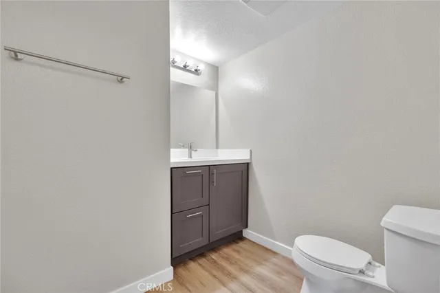 a bathroom with a sink a toilet a vanity and shower