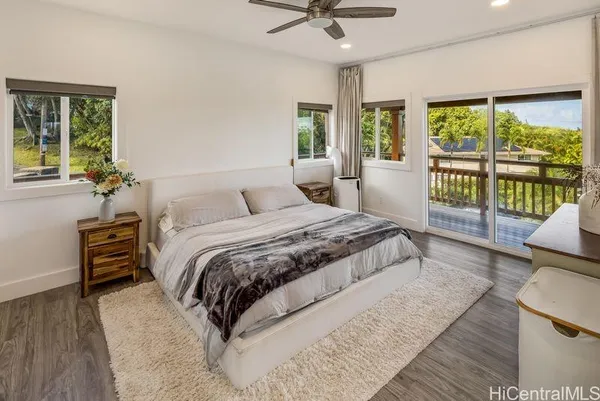a bedroom with a large bed and a chandelier