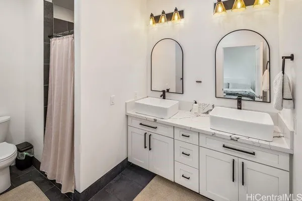 a spacious bathroom with a double vanity sink and mirror