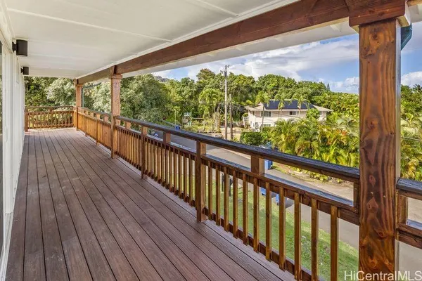 a view of a balcony with wooden floor