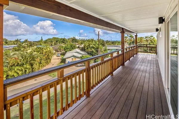 a view of a balcony with wooden floor