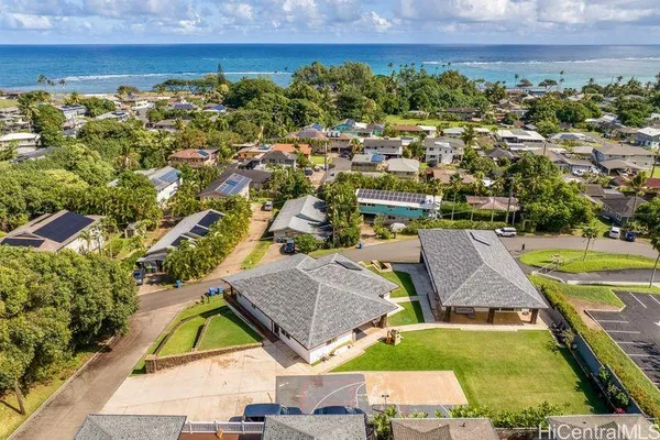 an aerial view of residential houses with outdoor space and swimming pool