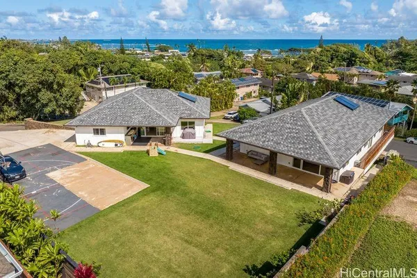 a aerial view of a house with swimming pool and a yard