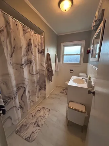 a bathroom with a sink toilet and shower