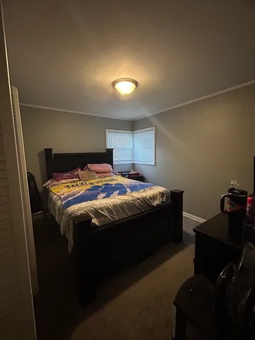 a bedroom with a bed and a desk