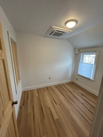 a view of a room with wooden floor and staircase