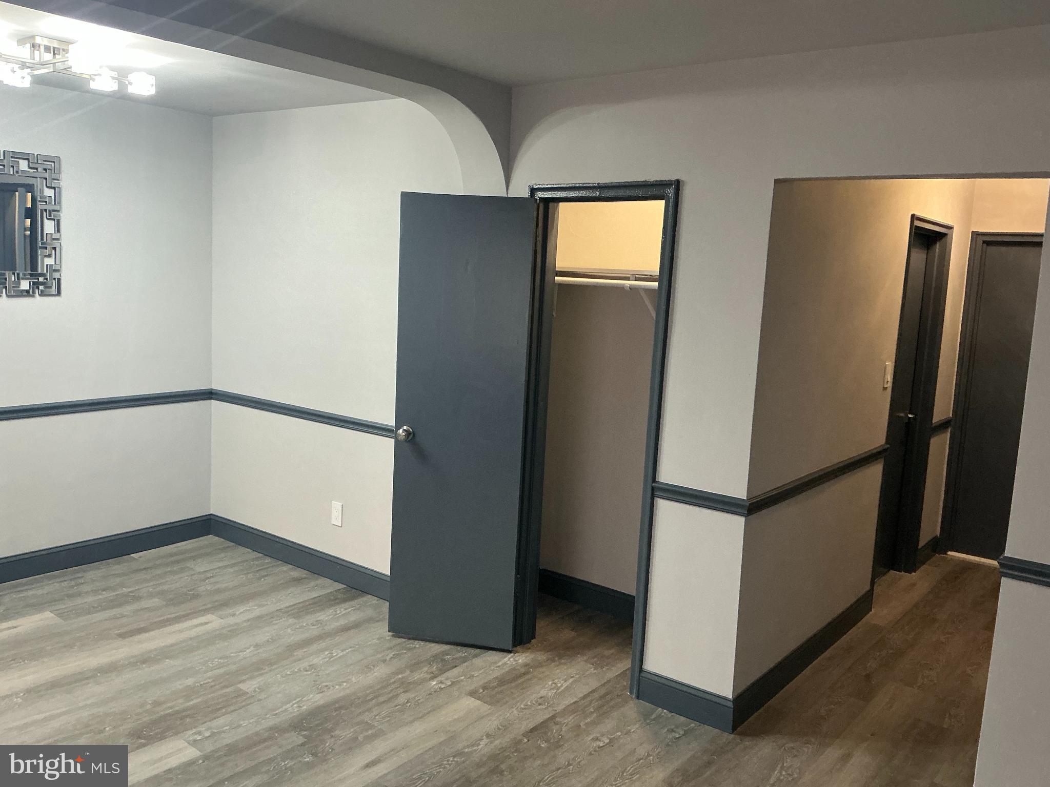 4004 E Street Southeast, Unit 106 Washington, DC 20019 - Photo 3 of 17 a view of empty room with wooden floor and fan