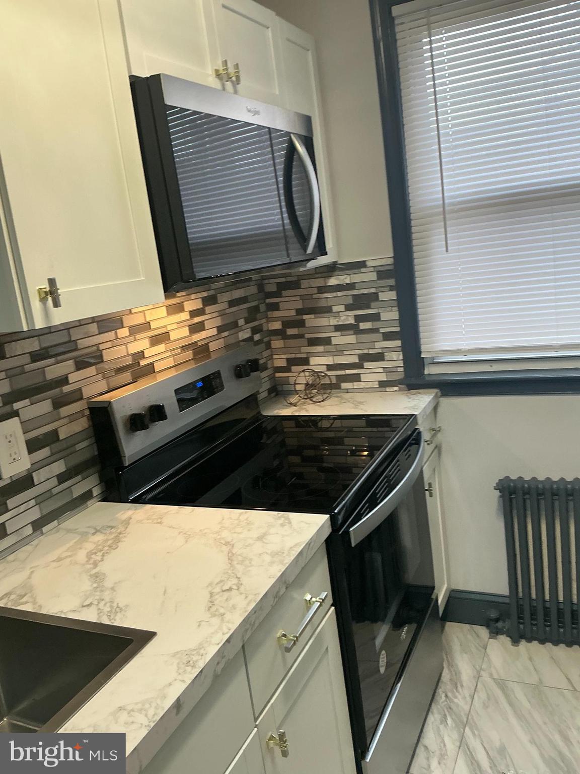 4004 E Street Southeast, Unit 106 Washington, DC 20019 - Photo 5 of 17 a close view of stove and microwave
