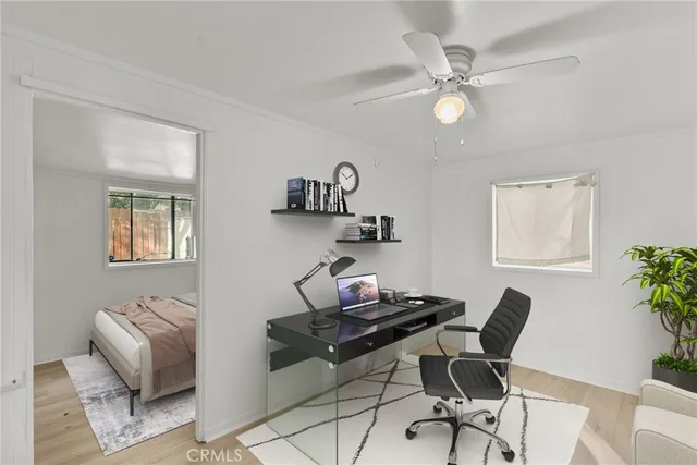 a view of a workspace with furniture and a window