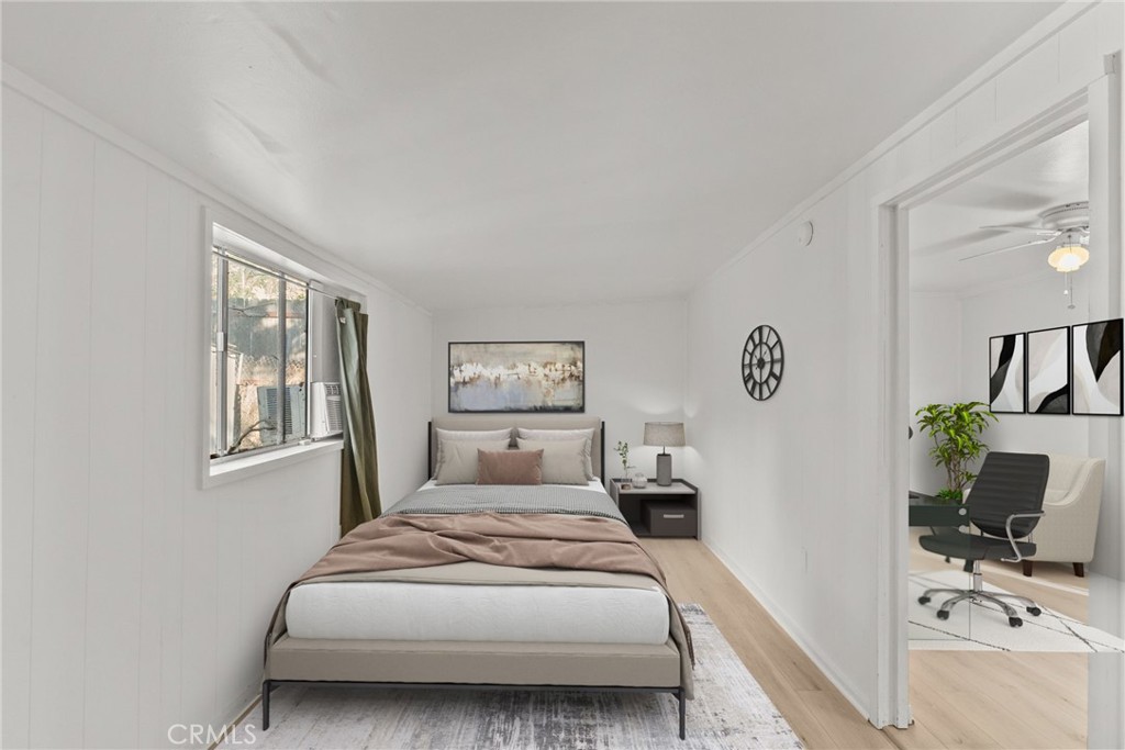 7053 Sunnycrest Trail Tujunga, CA 91042 - Photo 12 of 19 a bedroom with a bed and wooden floor
