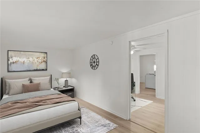 a bedroom with a bed and a painting on the wall