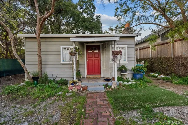 a front view of house with yard and outdoor seating