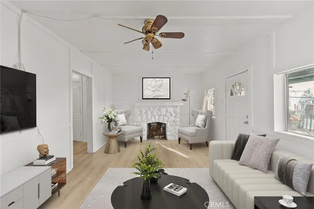 a living room with furniture a fireplace and a flat screen tv