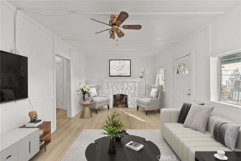 7053 Sunnycrest Trail Tujunga, CA 91042 - Photo 2 of 19 a living room with furniture a fireplace and a flat screen tv