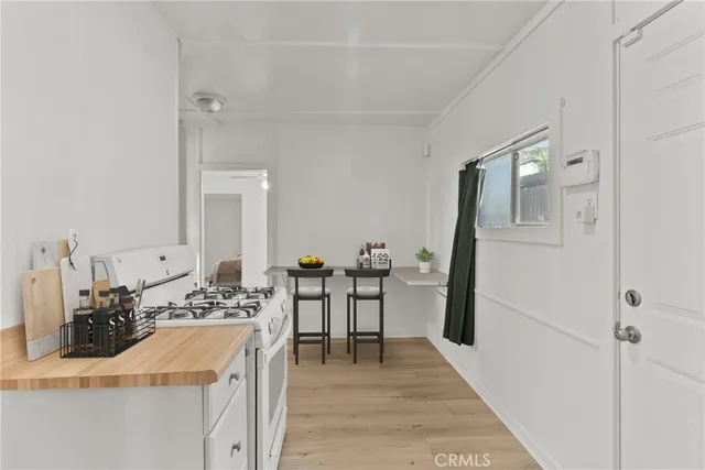a kitchen with a sink stove and refrigerator