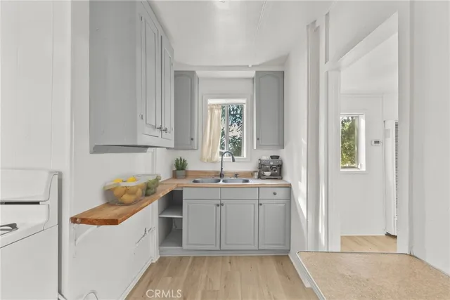 a kitchen with a sink cabinets and window