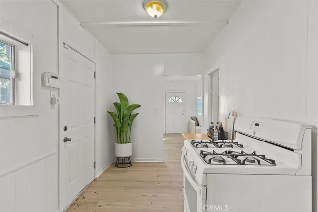 a white kitchen with sink and window