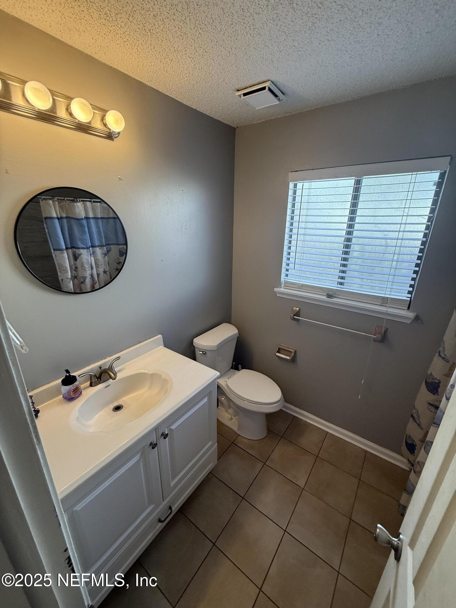 4026 Cedar Island Road East Jacksonville, FL 32250 - Photo 14 of 26 a bathroom with a sink a toilet and vanity