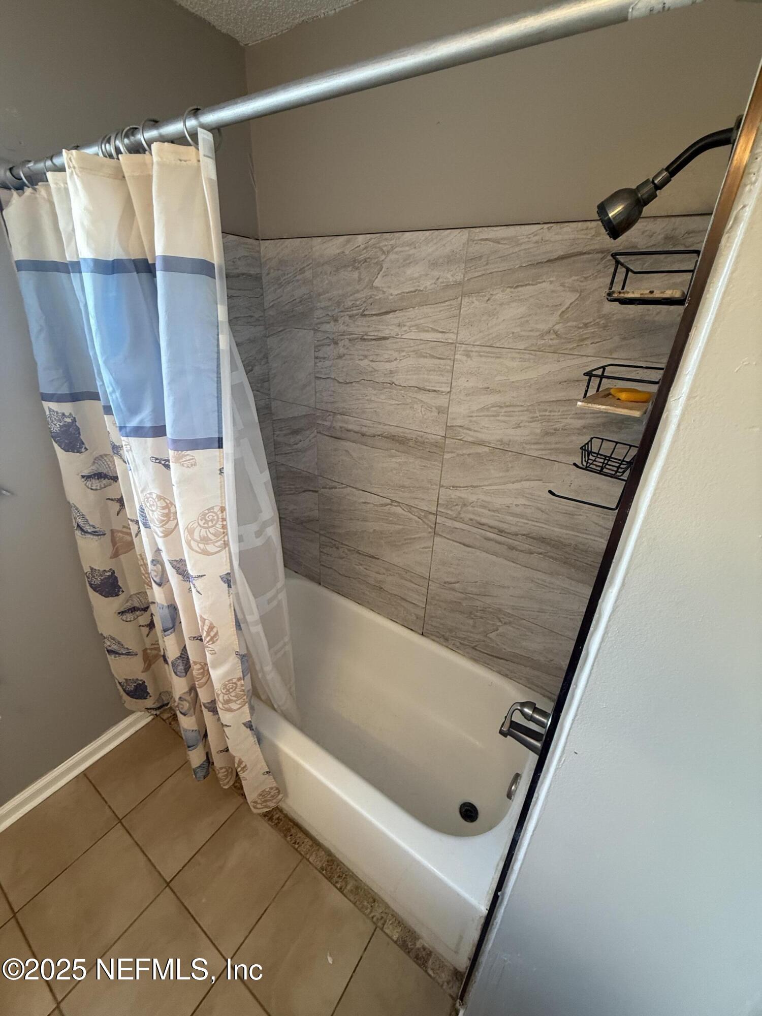 4026 Cedar Island Road East Jacksonville, FL 32250 - Photo 15 of 26 a bathroom with a bathtub