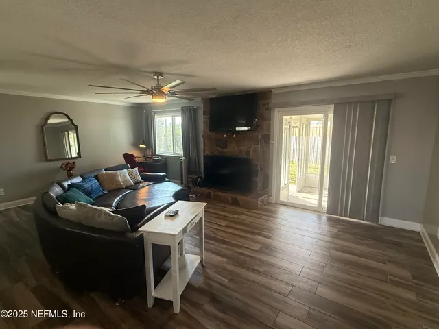 a living room with a bed furniture and a window