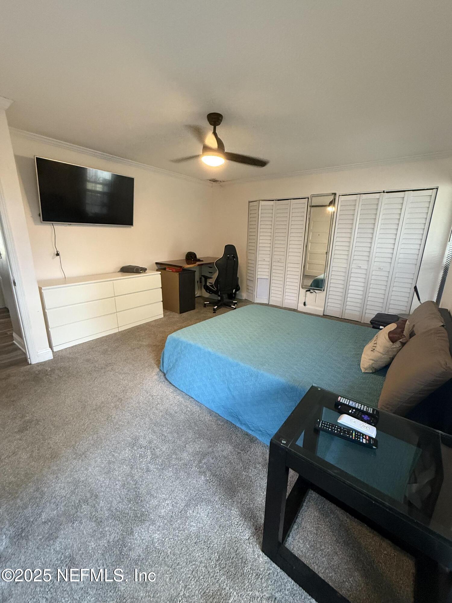4026 Cedar Island Road East Jacksonville, FL 32250 - Photo 10 of 26 a living room with furniture and a flat screen tv