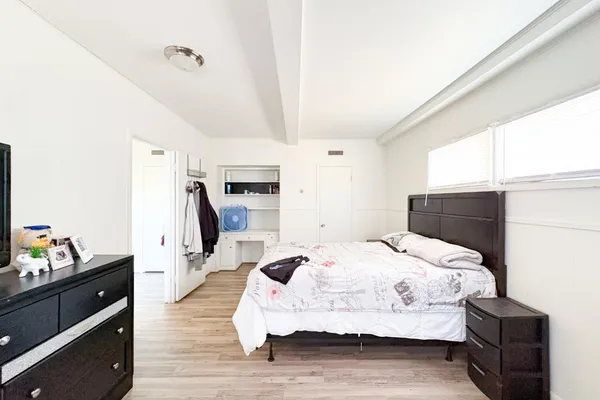 a bedroom with a bed and a dresser