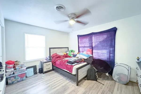 a bedroom with a bed and a dresser