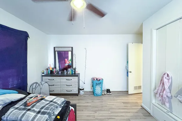 a bedroom with a bed and a dresser