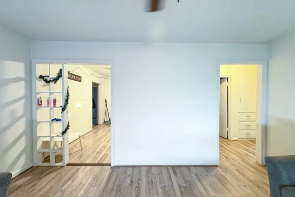 a view of walk in closet with wooden floor and door