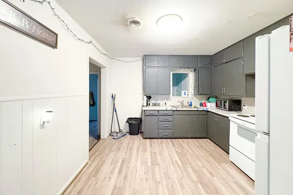 a kitchen with stainless steel appliances a refrigerator sink and cabinets