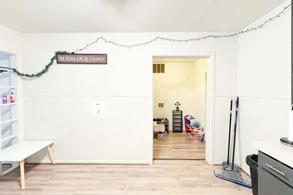 a view of a hallway with wooden floor and a floor to ceiling window