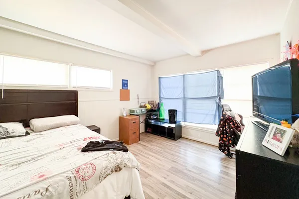 a bedroom with a bed and a flat screen tv