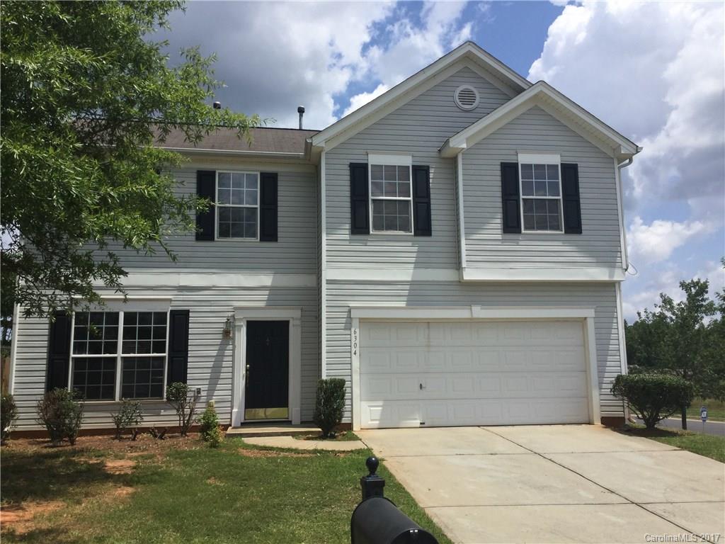 6304 Trotters Ridge Road Charlotte, NC 28227 - Photo 1 of 9 a front view of a house with a yard and garage