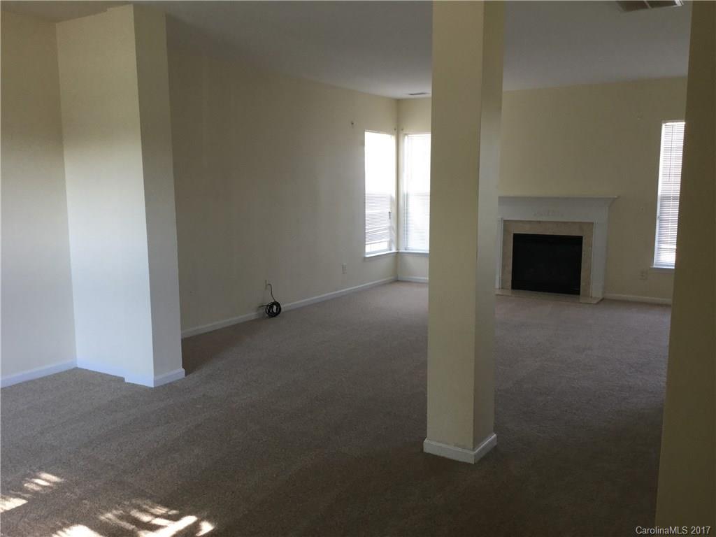6304 Trotters Ridge Road Charlotte, NC 28227 - Photo 4 of 9 a view of a livingroom with an empty space and a fireplace