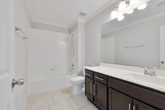 a bathroom with a sink a toilet a mirror and shower