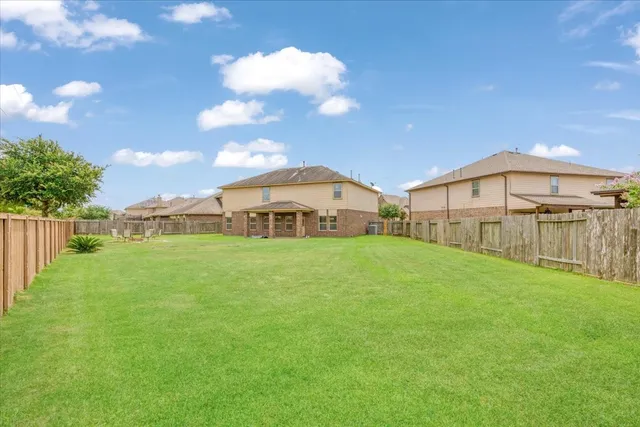 a view of a house with a backyard