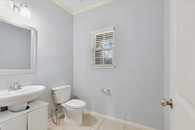 a white toilet sitting next to a bathroom sink