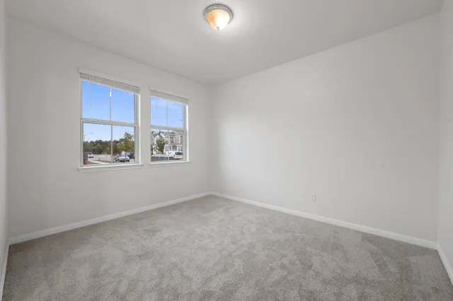 a living room with furniture a window and a potted plant