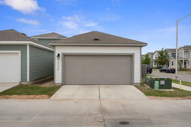 a view of a house with a yard and furniture