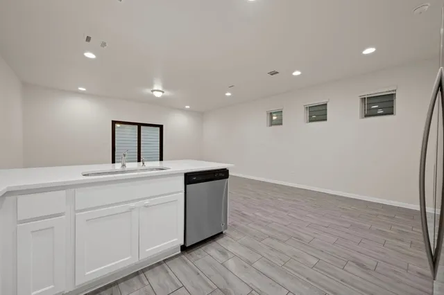 a kitchen with stainless steel appliances granite countertop a refrigerator and a stove top oven